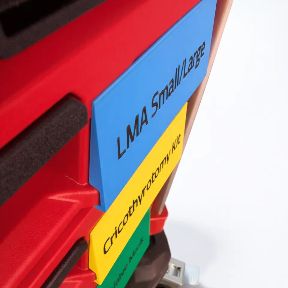 Close-up of CodeKit™ color-coded drawer labels showing the blue, yellow, and green visual system.