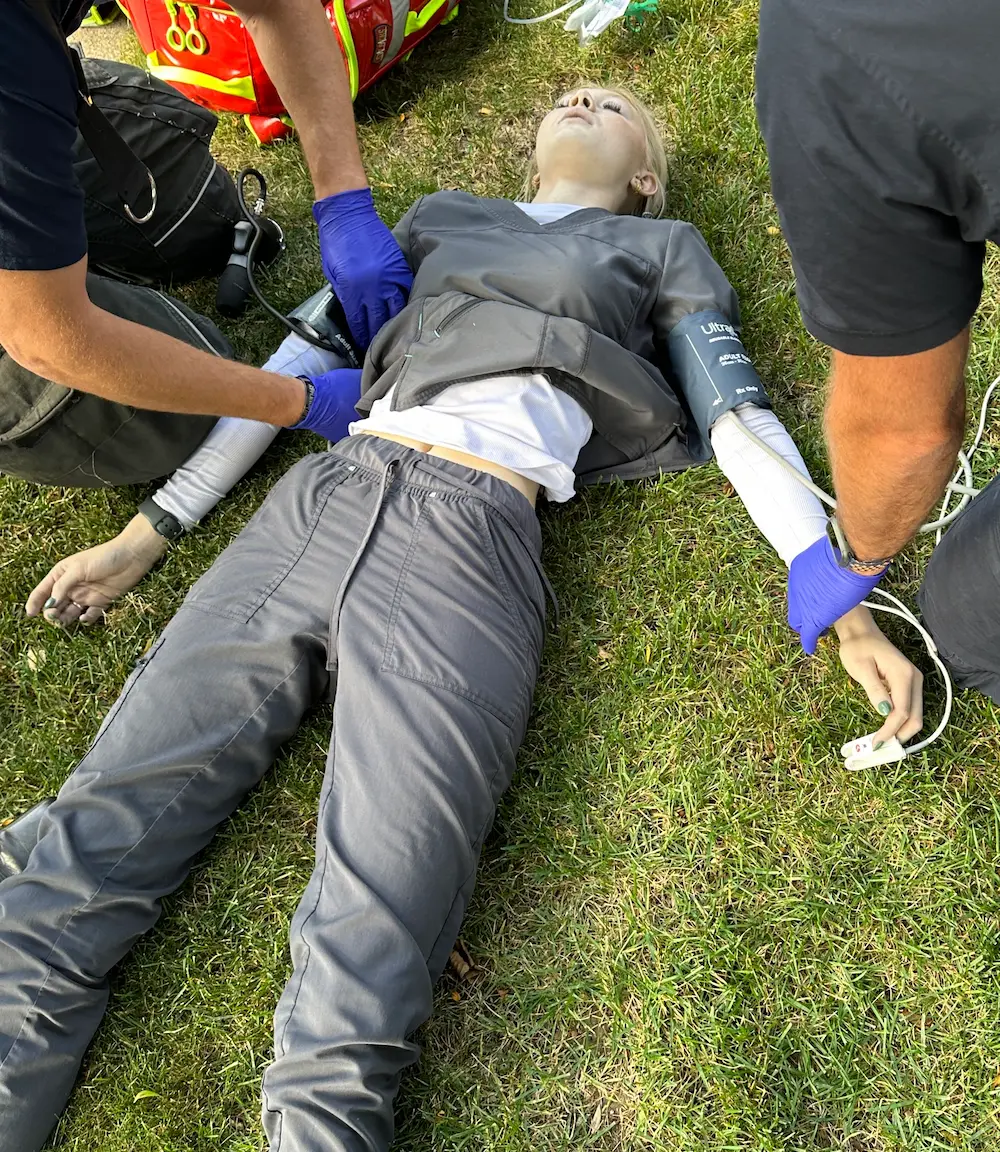 Patient on ground being treated by EMS