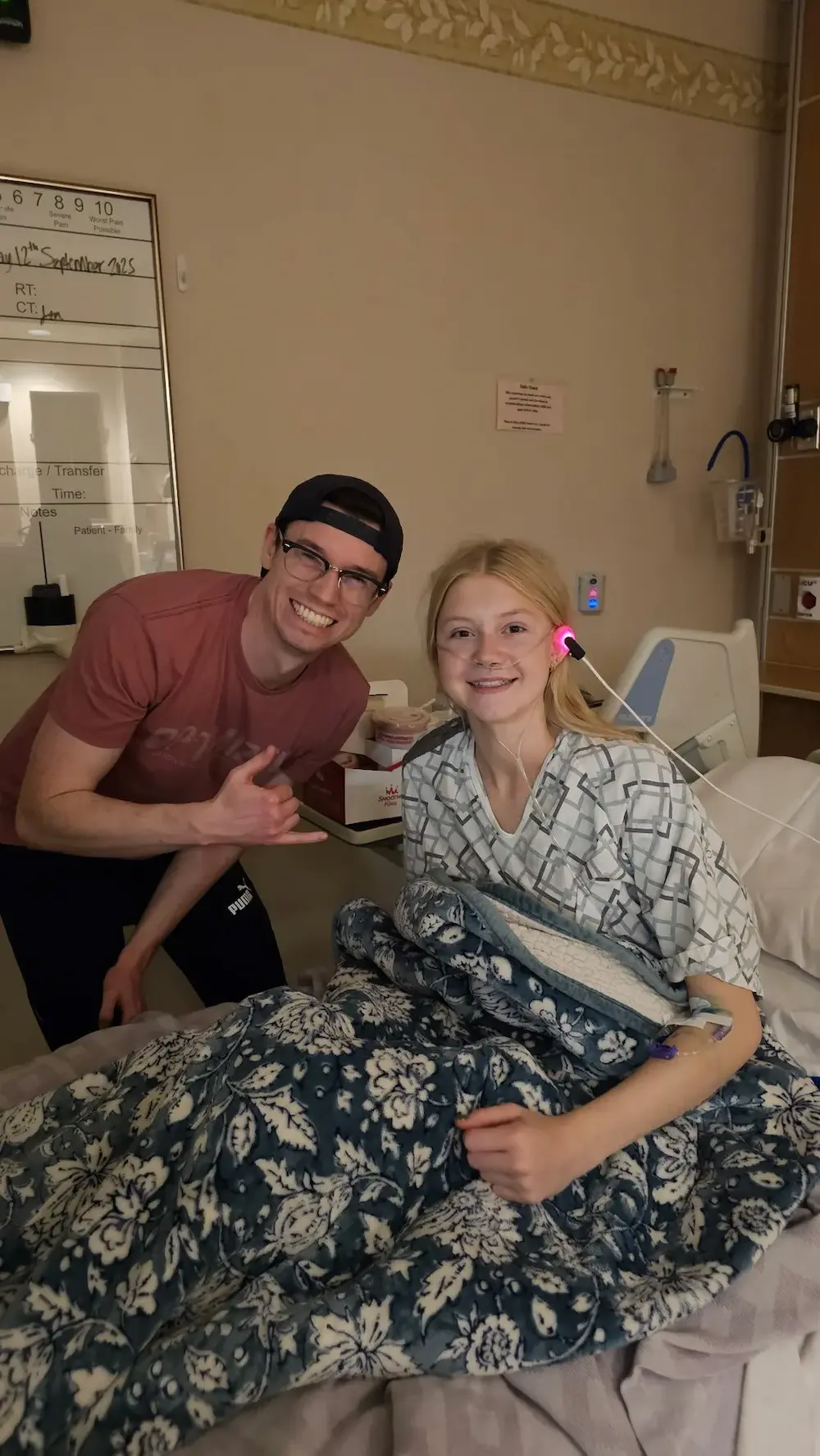 Patient healthy, sitting in hospital bed with doctor.